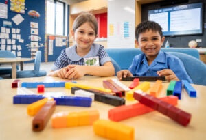 Primary school children work with blocks in a Mathematics lesson.